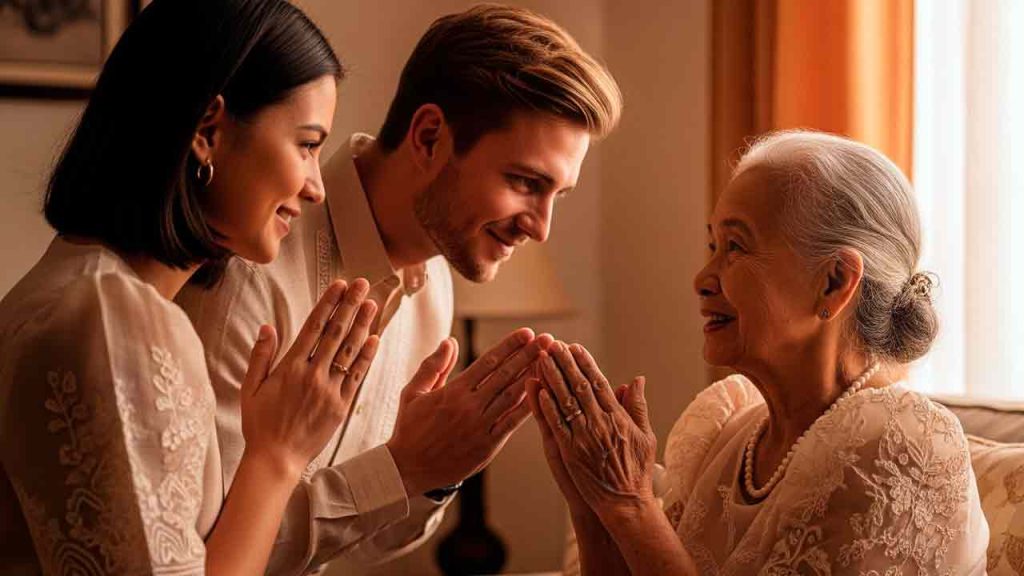 A young Filipino-Western couple performing the 'Mano Po' gesture of respect to an elderly Filipino woman.