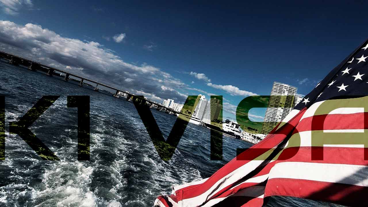A happy couple on a boat with the US flag, symbolizing the successful journey of a K-1 Fiancee visa.