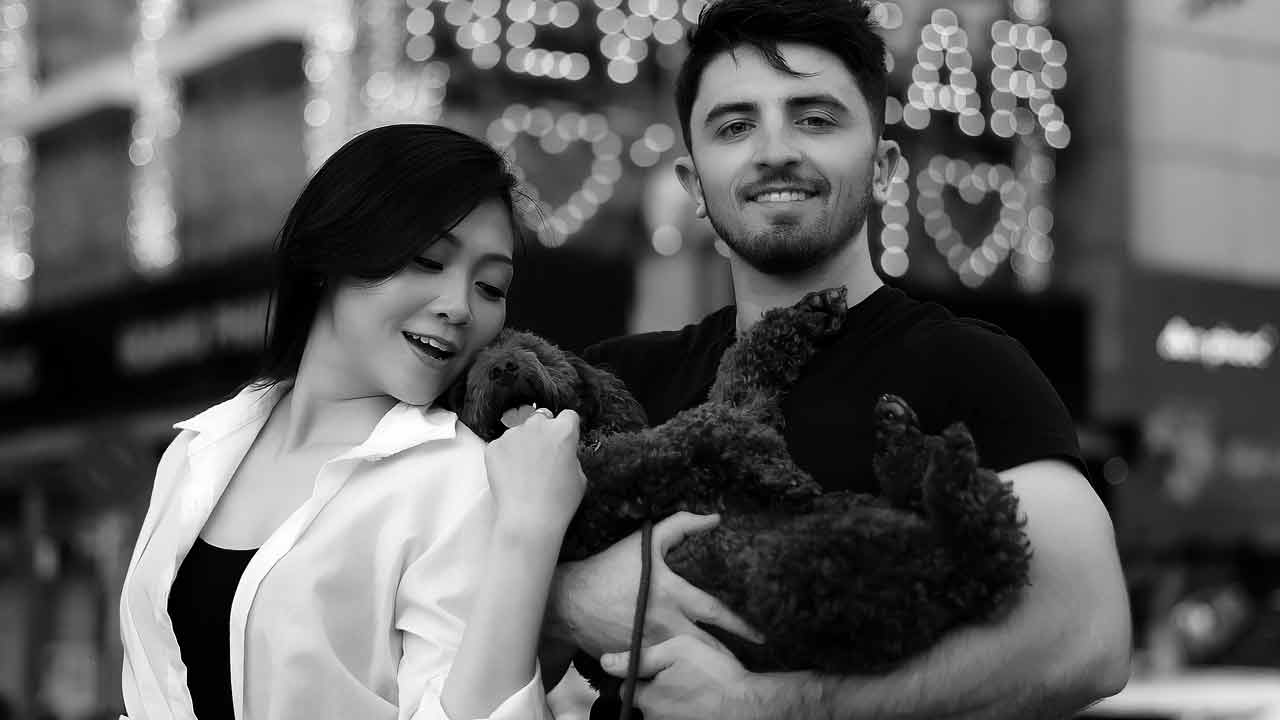 A happy intercultural couple, with a Western man and a Filipino woman, enjoying a romantic date outdoors.