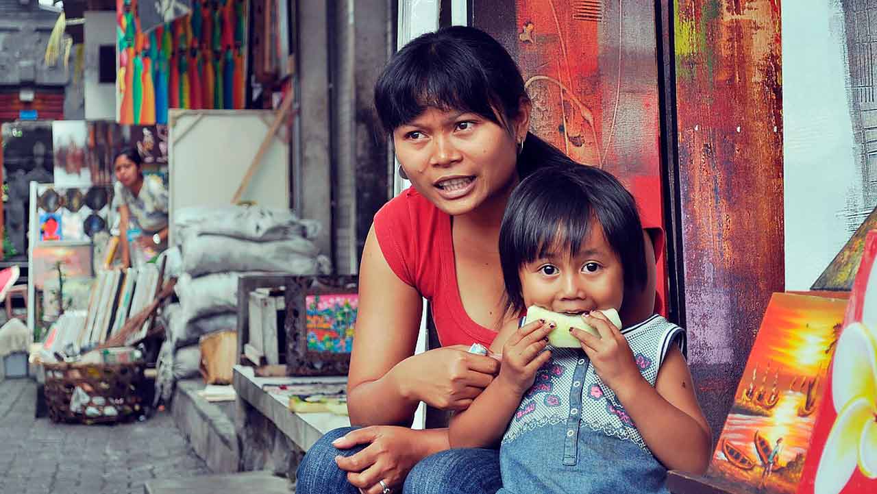 A Western man smiling as he meets the Filipino parents of his partner.