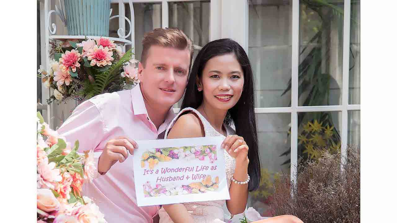 A happy married couple, showing that practical legal steps like prenups can lead to a secure and happy marriage.